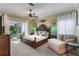 Main bedroom with a dark wood bed frame and plenty of natural light at 4260 Wordsworth Way, Venice, FL 34293