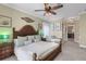 Spacious main bedroom features a large bed, ceiling fan, and ensuite bathroom access at 4260 Wordsworth Way, Venice, FL 34293