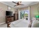 Light and airy main bedroom showcasing a ceiling fan and sliding glass doors to the lanai at 4260 Wordsworth Way, Venice, FL 34293