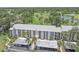 Condo building with golf course view, showcasing mature landscaping and convenient covered parking at 437 Cerromar Ln # 414, Venice, FL 34293