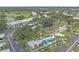 Aerial view of property including pool, lush landscaping, and a large parking lot at 437 Cerromar Ln # 414, Venice, FL 34293
