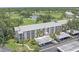 Aerial view of a multi-unit condo complex situated on a golf course near a lake at 437 Cerromar Ln # 414, Venice, FL 34293