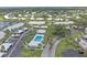 Aerial view of community featuring a pool, well-maintained landscaping, and convenient parking at 437 Cerromar Ln # 414, Venice, FL 34293