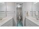 Bathroom featuring double sink vanity and shower at 437 Cerromar Ln # 414, Venice, FL 34293