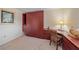 Bedroom features built-in closet, desk, chair and carpeted floors at 437 Cerromar Ln # 414, Venice, FL 34293