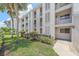 Exterior of condo building with balconies, lush greenery, and well-maintained landscaping at 437 Cerromar Ln # 414, Venice, FL 34293