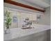 This kitchen boasts updated countertops, stainless appliances, and a stylish serving bar area for casual dining at 437 Cerromar Ln # 414, Venice, FL 34293