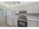 Bright kitchen features stainless steel appliances, white cabinets, and tile floors at 437 Cerromar Ln # 414, Venice, FL 34293