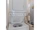 Compact laundry area featuring stacked washer and dryer at 437 Cerromar Ln # 414, Venice, FL 34293