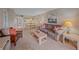 Comfortable living room boasts carpet, a couch, chairs and painting at 437 Cerromar Ln # 414, Venice, FL 34293
