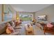 Cozy living room with plush seating and scenic views overlooking a golf course at 437 Cerromar Ln # 414, Venice, FL 34293