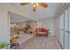 Bright living room features wood flooring, ceiling fan and large windows offering ample natural light at 437 Cerromar Ln # 414, Venice, FL 34293