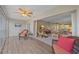 Spacious living room with ceiling fan, various seating arrangements, and sliding glass door at 437 Cerromar Ln # 414, Venice, FL 34293