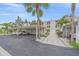 Assigned parking space in a well-maintained building with manicured landscaping and additional storage at 437 Cerromar Ln # 414, Venice, FL 34293