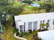 An aerial view of a condo building with a golf course and water feature in the background at 437 Cerromar Ln # 513, Venice, FL 34293