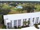 Aerial view of the condo community, pool, golf course, lake and lush landscaping at 437 Cerromar Ln # 513, Venice, FL 34293