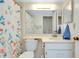 Bright bathroom featuring a floral shower curtain, vanity, and a mirror at 437 Cerromar Ln # 513, Venice, FL 34293