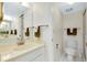 Bathroom featuring a toilet, shower, and single sink vanity with a large mirror at 437 Cerromar Ln # 513, Venice, FL 34293
