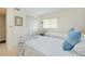 Cozy bedroom with natural light and two beds at 437 Cerromar Ln # 513, Venice, FL 34293