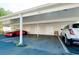 Community carport with designated parking and convenient storage; two cars parked at 437 Cerromar Ln # 513, Venice, FL 34293