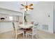 Cozy dining area with a round table, stylish chairs, and a ceiling fan at 437 Cerromar Ln # 513, Venice, FL 34293