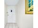 Clean entrance with tiled floor, a white door and a painting on the wall at 437 Cerromar Ln # 513, Venice, FL 34293