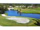 Scenic view of a lush green golf course with a tranquil pond and sand traps at 437 Cerromar Ln # 513, Venice, FL 34293