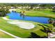Aerial view of the lush green golf course, pond and community at 437 Cerromar Ln # 513, Venice, FL 34293