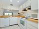 Bright, updated kitchen featuring white appliances, ample counter space, and tile flooring at 437 Cerromar Ln # 513, Venice, FL 34293