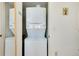 A compact laundry room with a stacked washer and dryer at 437 Cerromar Ln # 513, Venice, FL 34293