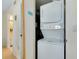 A compact laundry room with a stacked washer and dryer at 437 Cerromar Ln # 513, Venice, FL 34293