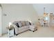 Comfortable living room featuring a sofa and a view of the adjacent dining area and kitchen at 437 Cerromar Ln # 513, Venice, FL 34293