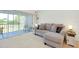 Living room with a comfortable sofa and sliding glass doors leading to a balcony at 437 Cerromar Ln # 513, Venice, FL 34293