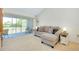 Inviting living room with a comfortable sofa and sliding glass doors leading to a balcony at 437 Cerromar Ln # 513, Venice, FL 34293