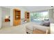 Bright living room featuring built-in shelving, neutral tones, and access to outdoor balcony at 437 Cerromar Ln # 513, Venice, FL 34293