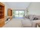 Bright living room with a comfortable sofa and sliding glass doors to a balcony overlooking greenery at 437 Cerromar Ln # 513, Venice, FL 34293