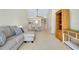 Spacious living room with a comfortable sofa and open access to the dining area and kitchen at 437 Cerromar Ln # 513, Venice, FL 34293
