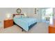 Comfortable bedroom with a king-sized bed and sliding glass door to the outdoor area at 437 Cerromar Ln # 513, Venice, FL 34293