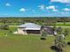 A quaint home featuring a screened-in pool area, landscaped yard, and picturesque natural surroundings at 48 Lark Dr, Placida, FL 33946