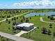 Aerial view of beautiful home with a paved driveway and a screened-in pool surrounded by palm trees at 48 Lark Dr, Placida, FL 33946