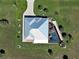 This aerial shot reveals a home's unique roof design and a well-maintained, screened-in pool area at 48 Lark Dr, Placida, FL 33946