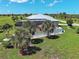 This home features a screened lanai and pool area in the backyard surrounded by lush greenery and mature landscaping at 48 Lark Dr, Placida, FL 33946