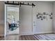 Stylish interior barn door that opens to reveal a garage with an RV at 48 Lark Dr, Placida, FL 33946