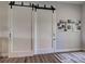 Stylish interior barn door with dark hardware and wood-look floors at 48 Lark Dr, Placida, FL 33946