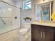 Updated bathroom with a tiled shower, vanity with granite countertop, and modern fixtures at 48 Lark Dr, Placida, FL 33946