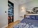 Cozy bedroom featuring a well-organized closet, stylish decor, and a comfortable blue bed at 48 Lark Dr, Placida, FL 33946