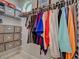 Organized closet with shelving and hanging space, filled with a variety of clothes and storage boxes at 48 Lark Dr, Placida, FL 33946