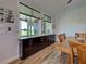 Dining area featuring natural light from large windows, wooden floors, and stylish design at 48 Lark Dr, Placida, FL 33946