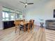 Dining room featuring wood floors, a large table, and natural light through multiple windows at 48 Lark Dr, Placida, FL 33946