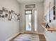 Entryway with hard surface flooring, white trim, gallery wall, and a frosted glass front door at 48 Lark Dr, Placida, FL 33946
